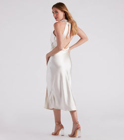 Turn heads at Prom 2025 in this ivory prom dress, where statement-making details meet the iconic style of the Ingrid Formal Satin Halter Dress .