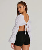 The Official Cutie Tie Back Long Sleeve Crop Top is a women's long-sleeve top with an elevated style and unique design accents, perfect for layering or transitioning into colder months.